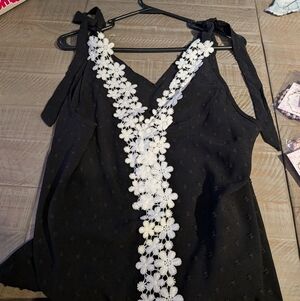 Black Sleeveless Top with White Floral Detail